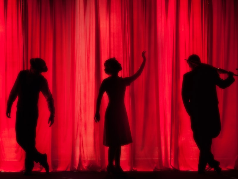 Performers silhouetted on stage